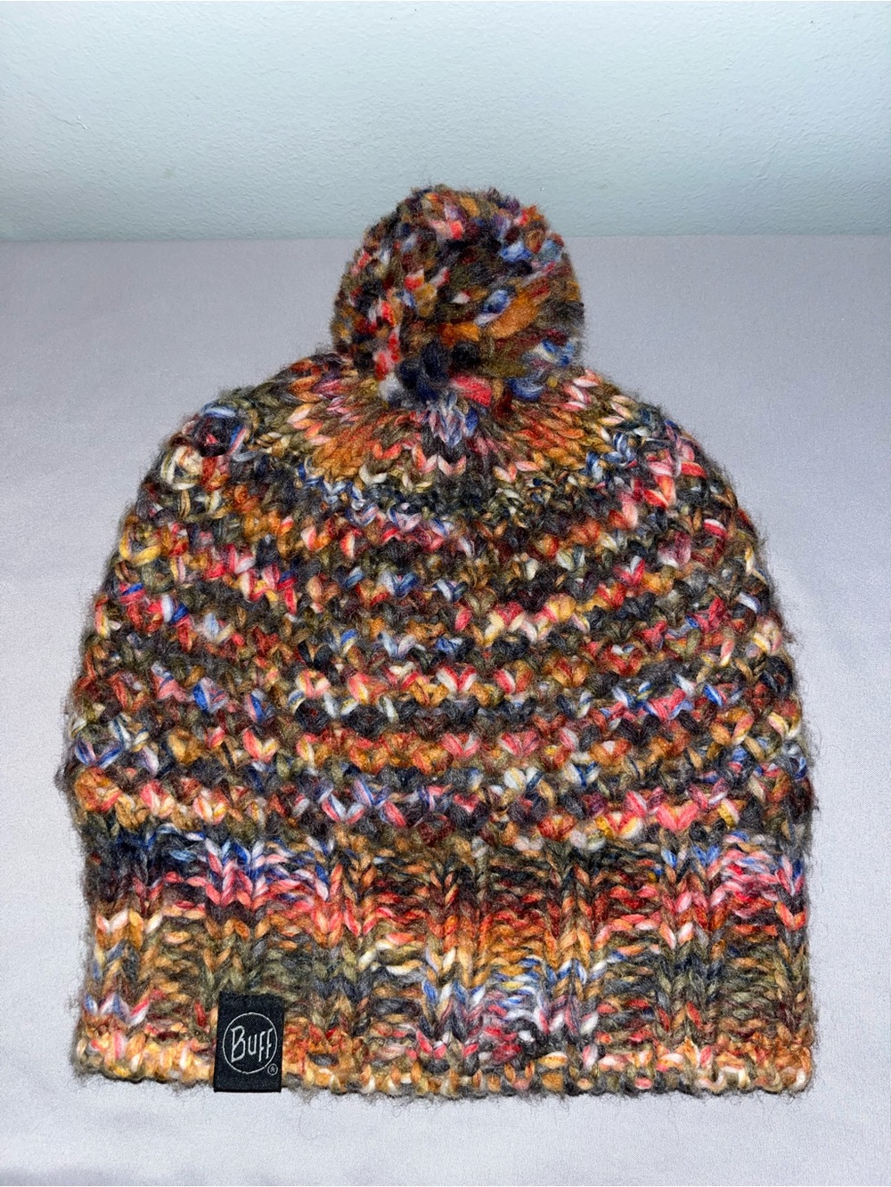 BUFF Knitted & Polar Hat in the "Margo Orange" multi-color pattern,